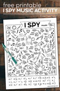 I spy music themed activity on wood background with pen and text overlay- free printable I spy music activity