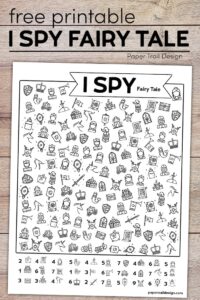 I spy activity on wood background with text overlay- free printable I spy fairy tale