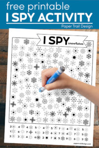 Kids winter I spy snowflake activity with kids hand holding marker with text overlay- free printable I spy activity 