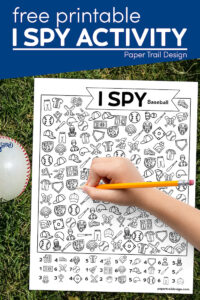 I spy baseball activity with kids hand holding pencil and a baseball in the grass with text overlay- free printable I spy activity