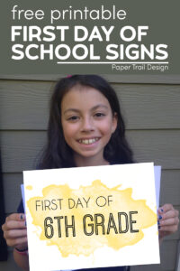 kid holding first day of 6th grade sign with text overlay- free printable first day of school signs