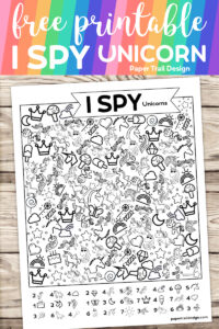 Unicorn I spy activity page printable on a wood and rainbow background with text overlay- free printable I spy unicorn