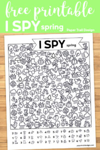 I spy activity page on wood background with text overlay- free printable I spy spring. 