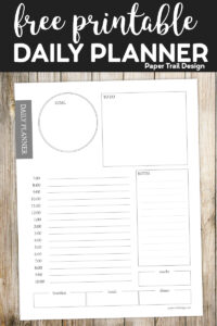 Simple day planner page on wood background with text overlay- free printable daily planner