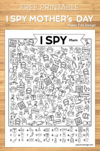 I Spy mother's day theme printable with pictures of moms, cards, flowers, and gifts to find on wood background with text overlay- free printable I spy Mother's Day