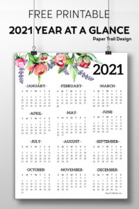 2021 one page calendar with floral elements hanging from two wires attached to clips with text overlay- free printable 2021 year at a glance