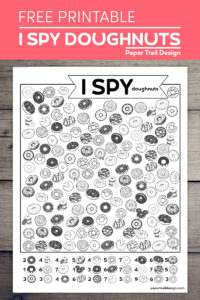 I spy donut themed activity page on a wood background with text overlay free printable I spy doughnuts