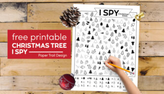 Christmas tree themed I spy activity with kid's hand holding pencil with text overlay- free printable Christmas tree I spy